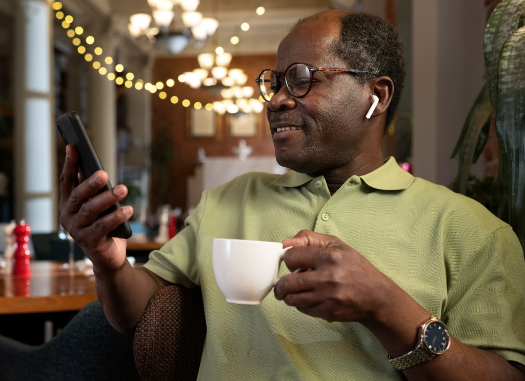 Man checking phone with coffee